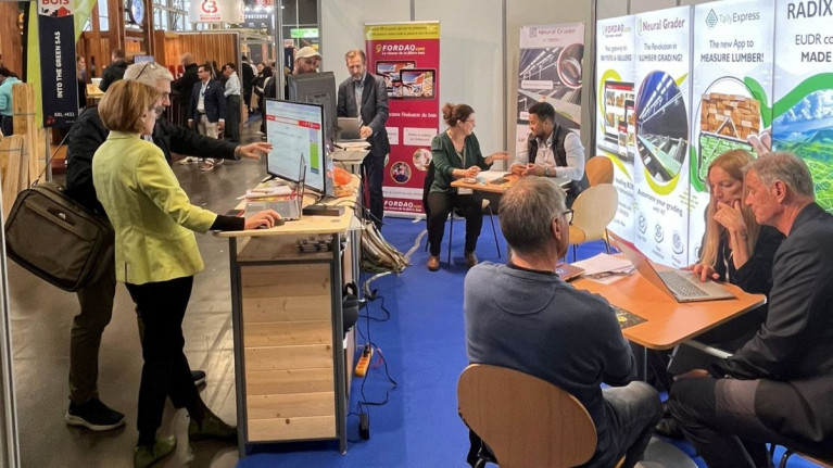 Visitors and Fordaq representatives at the company’s exhibition stand, featuring Fordaq.com, Neural Grader and TallyExpress.