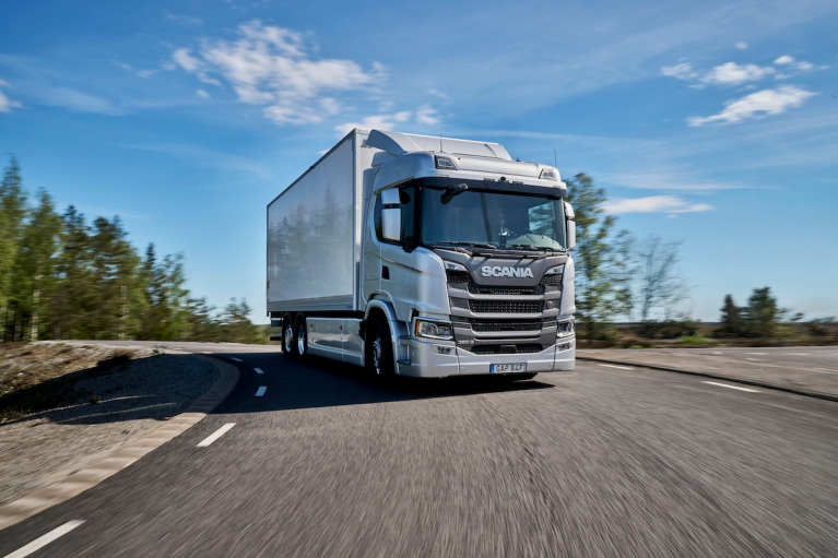Silver Scania 390 G truck driving on a road.