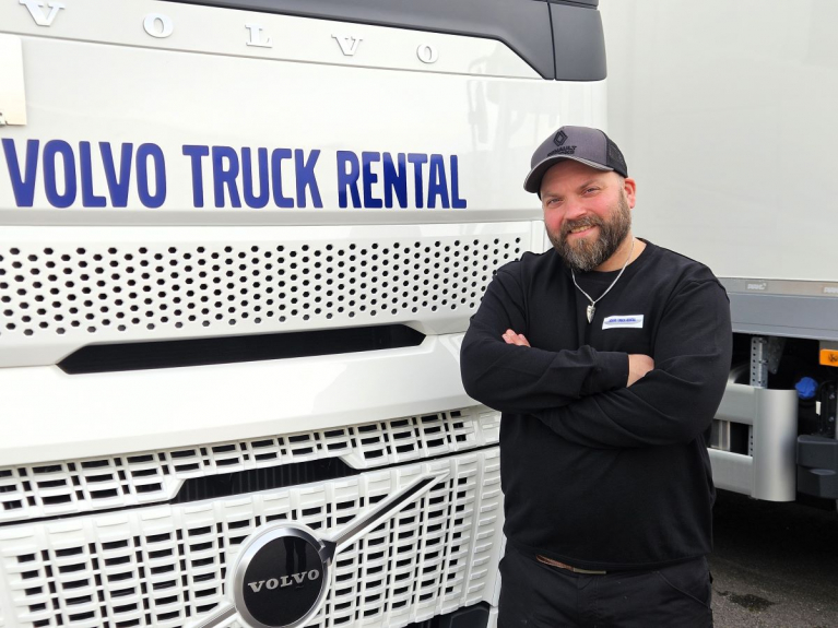 Juho Teittinen seisoo kädet ristissä Volvo Truck Rentalin valkoisen kuorma-auton edessä.