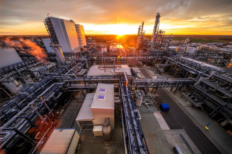 UPM’s Leuna biorefinery in Germany, with processing towers and pipework illuminated by the low sun.
