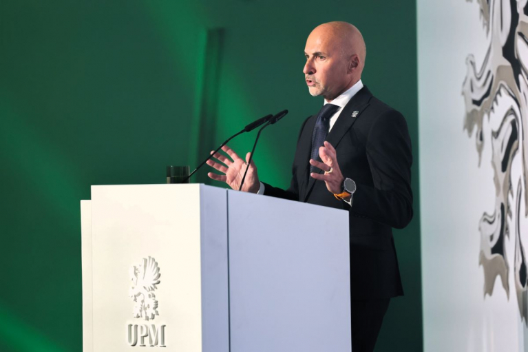UPM President and CEO Massimo Reynaudo speaking behind a lectern bearing the UPM logo.