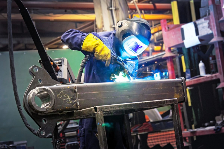 A welder working on a metal component at Kesla’s production facility.